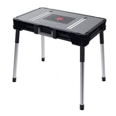 a black table with metal legs and a red button on it