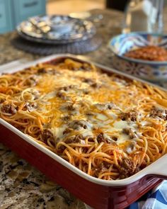 a casserole dish with meat and cheese in it on a kitchen counter top