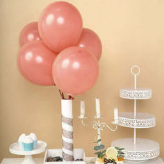 a table with cake, cupcakes and balloons on it for a birthday party