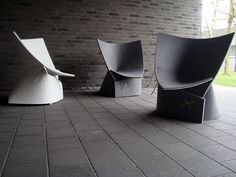 three chairs sitting on top of a brick floor