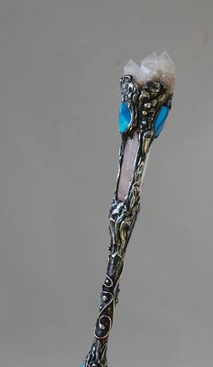 an ornate toothbrush with blue and white crystals