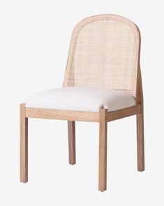 the back side of a wooden chair with a white seat pad on top of it