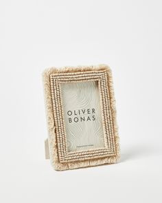 a white square frame with the words silver bonas in black lettering on it, sitting against a white background