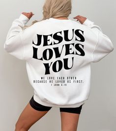 Jesus Loves You Sweatshirt, 1 John 4:19 Shirt, Christian Merch Hoodie For Catholic Mom, Aesthetic Religious Gift, Bible Verse Shirt, RN112 ♥️ WELCOME ♥️ Looking for super soft, comfy, and high-quality clothes for your special days or loved ones? You've come to the right place! We absolutely love what we do and are dedicated to making your shopping experience just perfect. If you have any questions about our products, don't hesitate to reach out. We're here to help and will get back to you as soon as possible! 🔵 HOW TO ORDER  1️⃣Select the t-shirt size 2️⃣ Select the color 3️⃣ If you have, add your personalized designs, enter customization in "Add your personalization" field 4️⃣ Add to cart 5️⃣ Go back and Repeat for each size (to create a set ) ♻️ CARE INSTRUCTIONS  🟢 Wash item inside ou Jesus Merch Aesthetic, Catholic T Shirt, Jesus Love Blouses, All We Need Is Jesus Hoodie, Jesus Loves You Hoodie, 1 John 4 19, Christian Tshirt Design, John 4, Jesus Loves You