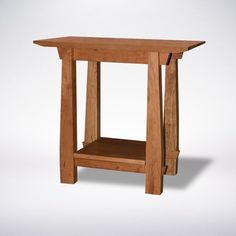 a small wooden table with one shelf on the side