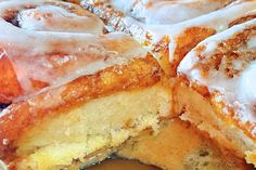 a close up of some food with icing on it's crust and one slice cut in half