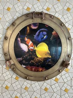 there is an image of fish in the water through a porthole on the wall