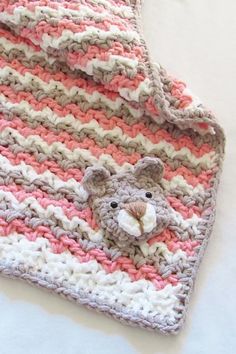 a crocheted blanket with a teddy bear on it