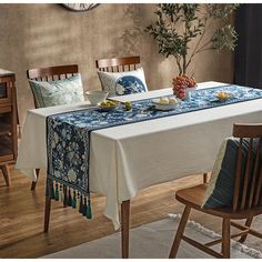 a dining room table covered with blue and white linens