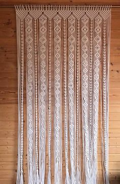 the wall hanging is made from white yarn