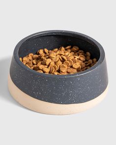 a dog bowl filled with food on top of a white table