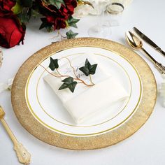 a white and gold plate topped with a piece of cake on top of a table