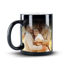 a black coffee mug with an image of two people and a baby in the middle