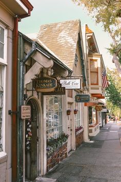 a row of shops on the side of a street