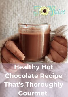 a woman holding a cup of hot chocolate in her hands with the words healthy hot chocolate recipe that's thoroughly gourmet