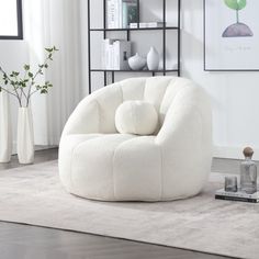 a white chair sitting on top of a rug in a living room