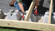 a man is working on some concrete blocks