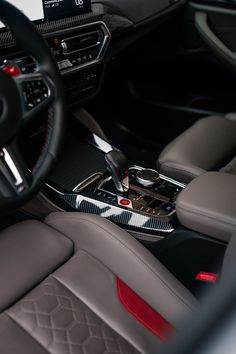 the interior of a car with steering wheel and center console