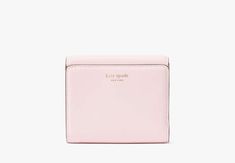 Say hello to our new icon. Made from smooth leather the Dakota features our signature K hardware for a bold modern look. Settle your tab in style with this compact bifold flap wallet. | Kate Spade Dakota Bifold Flap Wallet, Shimmer Pink Luxury Rectangular Kate Spade Wallet, Affordable Elegant Kate Spade Wallets, Cheap Kate Spade Wallets With Card Slots, Pink Wallet, Kate Spade Wallet, Christmas Wishlist, Kate Spade New York, Say Hello, Smooth Leather