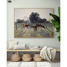 a painting hanging on the wall above a wooden bench with baskets and plants in front of it