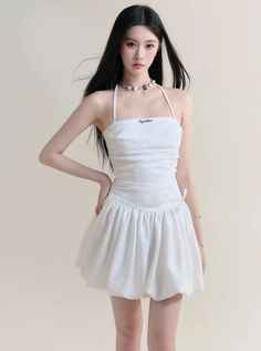 This sophisticated halter sundress features a stunning ruched bodice that accentuates your curves. The angelic white color adds a touch of elegance to your summer wardrobe. Stay cool and stylish in this mini dress, perfect for any occasion.  Model info: Height: 169 cm, Weight: 47 kg, Size worn: S Halter Sundress, Ballet Style, Ballet Fashion, Mini Sundress, Ruched Bodice, Neck Strap, Tutu Dress, Halter Neck, Summer Wardrobe