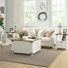 a living room filled with furniture and a large clock mounted to the wall above it