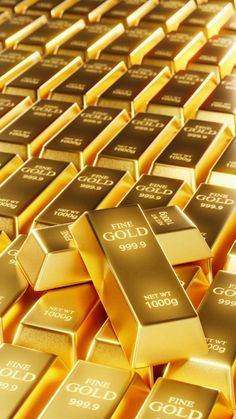 gold bars are arranged in rows on top of each other, with the sun shining through them