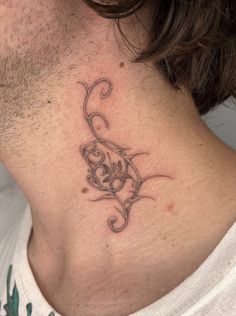 a man's neck with a tattoo on the back of his neck is shown