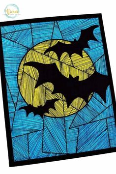 a stained glass window with bats flying over the moon in blue and yellow, on a white background