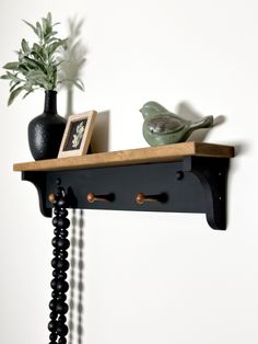 a black shelf with two birds on it