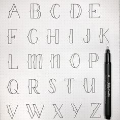 the letters and numbers are drawn on a sheet of paper with a pen in it