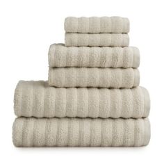 six white towels stacked on top of each other