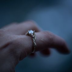 a person's hand with a ring on it