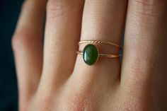 STUNNING 14k gold filled or Sterling Silver handmade Nephrite Jade ring set ✨ * Listing covers both the  Nephrite Jade ring and twisted band.  Beautiful 8x6mm natural oval olive green Jade gemstone✨⚒️  Jade is a special stone that is believed to promote wisdom, balance, and peace. Jade has a history that traces back to prehistoric times, to the ancient Chinese, the Maori, and to the Aztecs and Inca peoples of Central America.  Reputed by folklore to attract love, this stone was also believed to deliver prosperity and power to those who wore or carried it. * Please note photos are zoomed in up close, therefore the size of the stone may appear slightly larger in photos. Model is wearing a size US 5.5. Please refer to stone measurement to best determine the size & look you're looking for.  Ma Jade Stone Engagement Ring, Vintage Jade Ring, Jade Gold Ring, Gold Ring Green Stone, Jade Wedding Ring, Jade Rings For Women, Jade Engagement Ring, Jade Wedding, Jade Rings