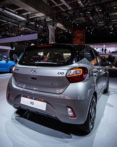 the rear end of a car on display at an auto show