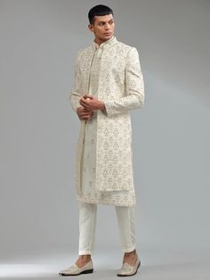 This elegant cream Indowestern, crafted from silk fabric, features intricate embroidery, sequins and zari that beautifully combines traditional and modern design elements. The ensemble includes a bottom. Sherwani For Men, Wedding Sherwani, Cream Silk, Intricate Embroidery