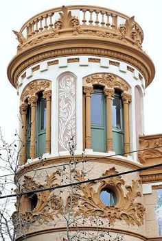 an ornate building with green shutters and windows