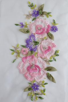 some pink and purple flowers on a white cloth