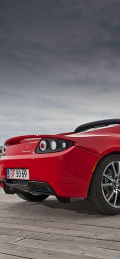 a red sports car is parked on the street