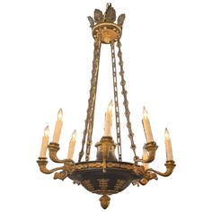 a chandelier with many candles hanging from it's center and four arms