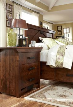 a bedroom with a bed, night stand and dresser