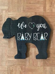 an elephant shaped wooden sign that says, we love you baby bear