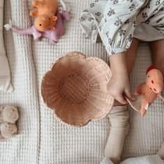 a child is playing with toys on the bed in their bedroom, top view from above