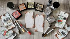 several different types of paint sitting on top of a wooden table next to other items