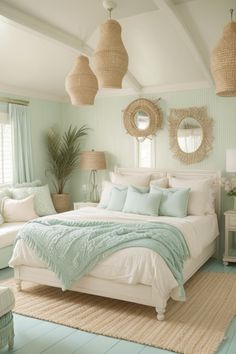 a bed room with a neatly made bed and two mirrors on the wall above it