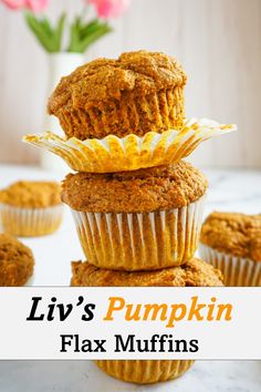 some muffins stacked on top of each other with the words liv's pumpkin flax muffins