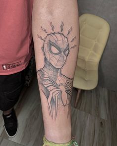 a person with a spiderman tattoo on their arm