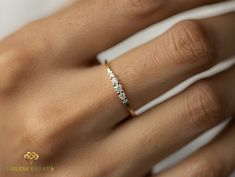 a woman's hand with a diamond ring on it