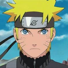 naruto is looking at the camera while wearing a black and grey outfit with blue eyes