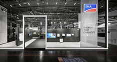 an exhibition room with glass doors and signs on the walls that read sma energy that changes